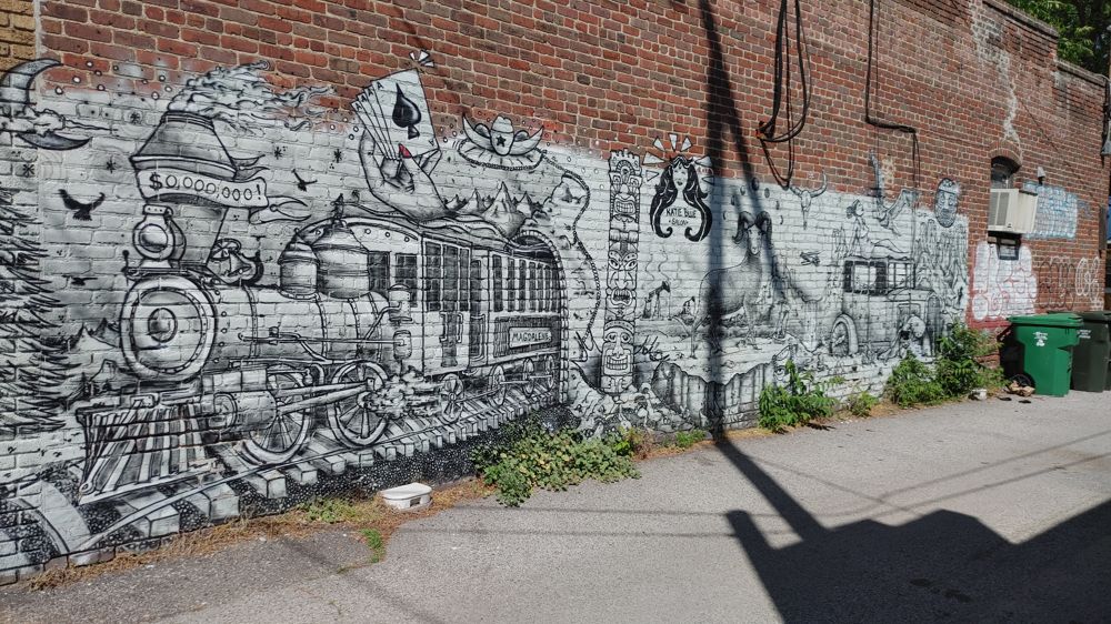 image of street art featuring an old steam locomotive among other characters