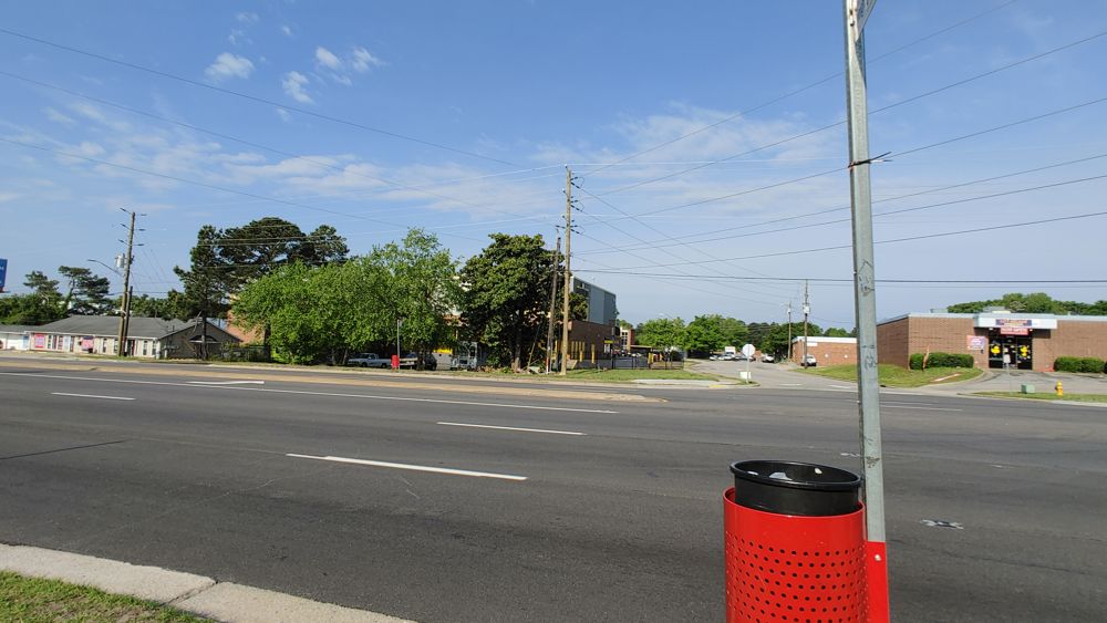 A major through-road with 4 lanes in each direction. No cars are in the photo, but it's a rare moment without them