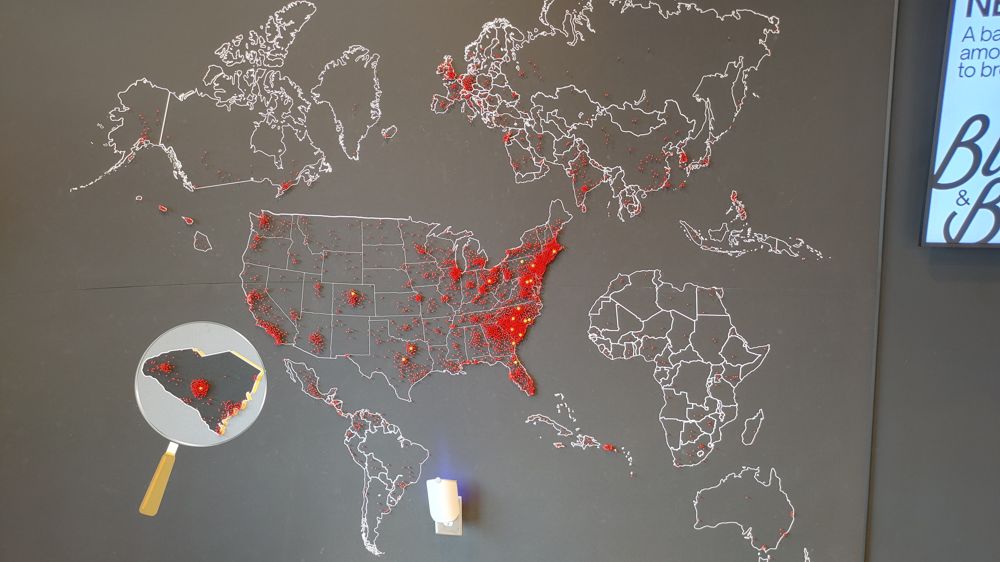 pin map of where people came from to visit their stores. Yellow pins mark the locations and red pins mark where they're from. The map shows people from all over the world.