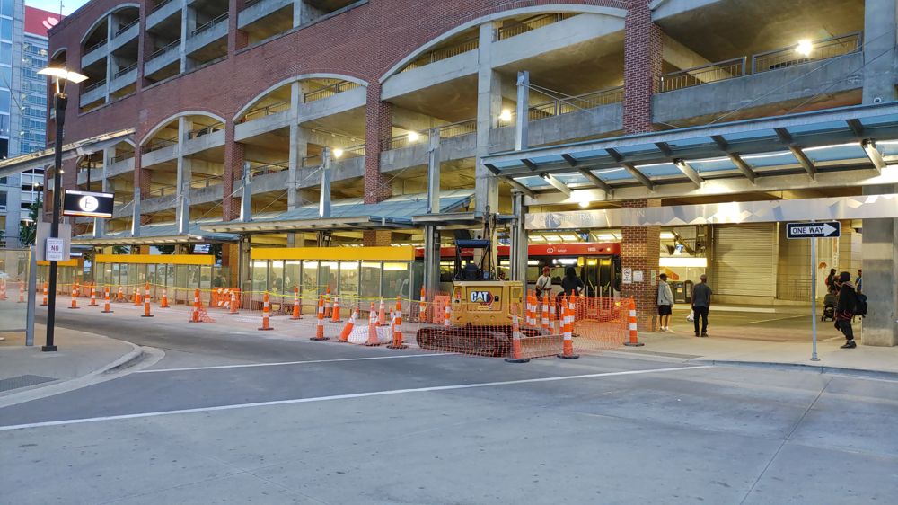 photo from the outside of the bus terminal in Raleigh. There are construction cones, but behind it is the covered portion where all of the buses arrive